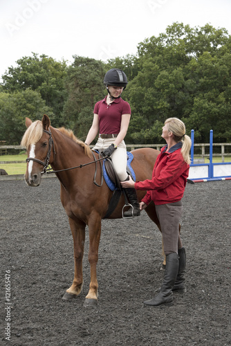 Young pony rider sitting in the saddle - September 2016 - Teenager learning to ride with the instructor