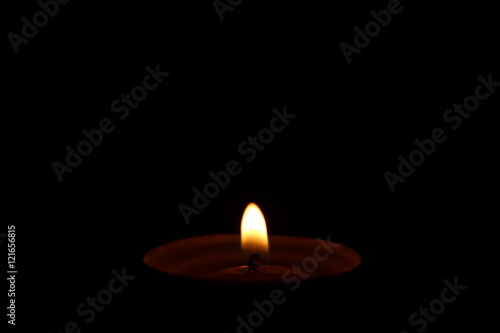 Candle flame on black background. Copy space.