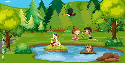 Boy and girl playing by the pond