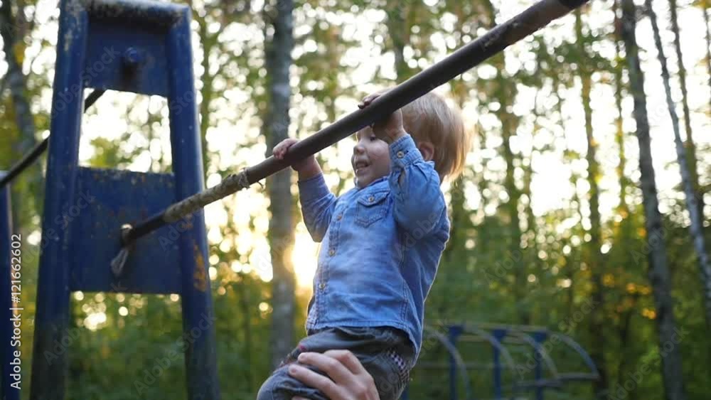 little child practicing on the horizontal bar little child practicing on the horizontal bar