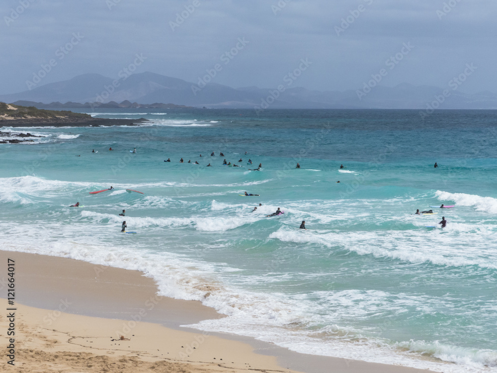 Surfer at a popular beach break on Fuerteventura. Surfer at a popular beach break on Fuerteventura.