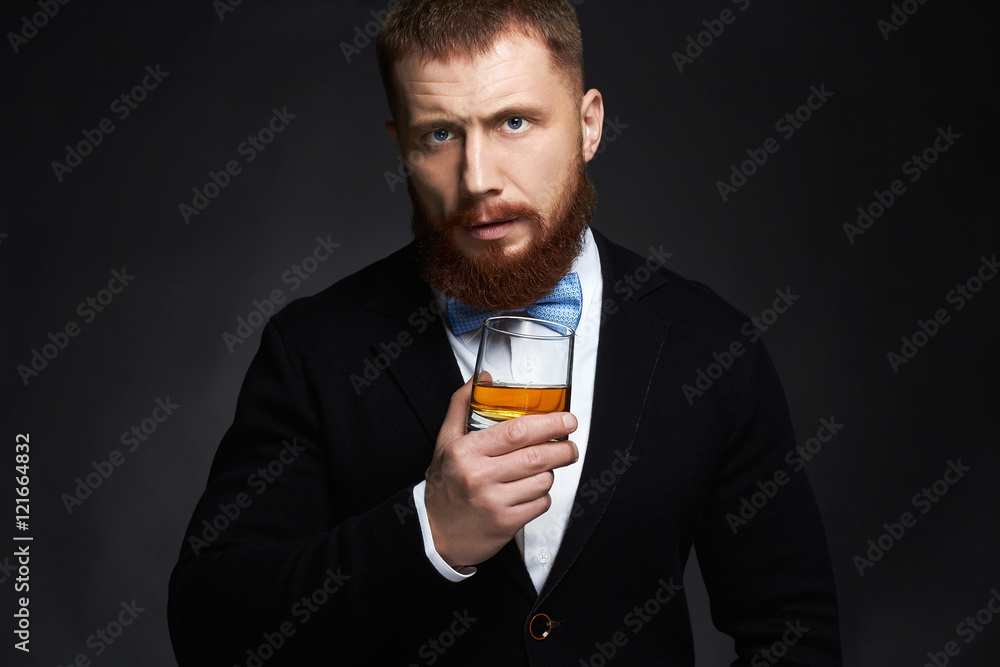 stylish handsome bearded man enjoying whiskey.Elegant man drinking alcohol stylish handsome bearded man enjoying whiskey.Elegant man drinking alcohol