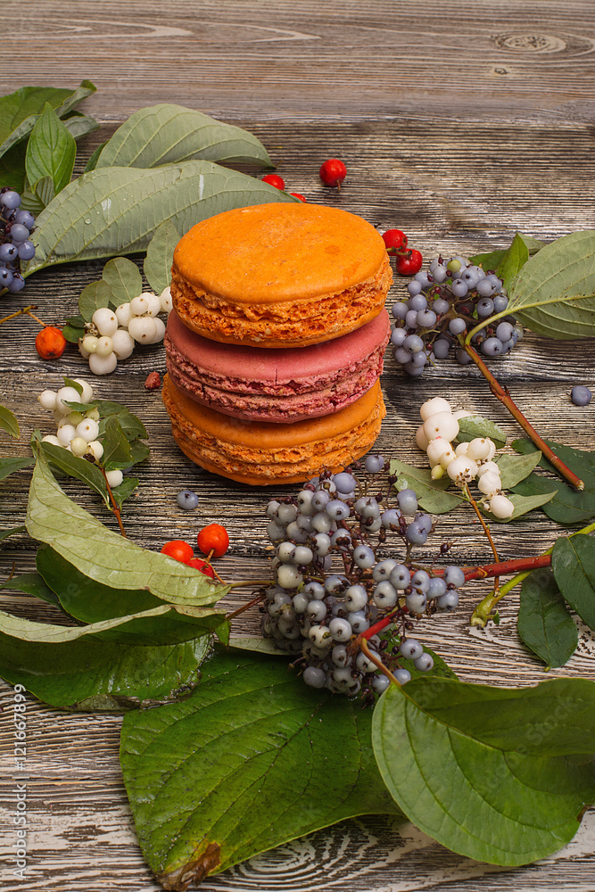 dessert macaroons with berries on a wooden table dessert macaroons with berries on a wooden table
