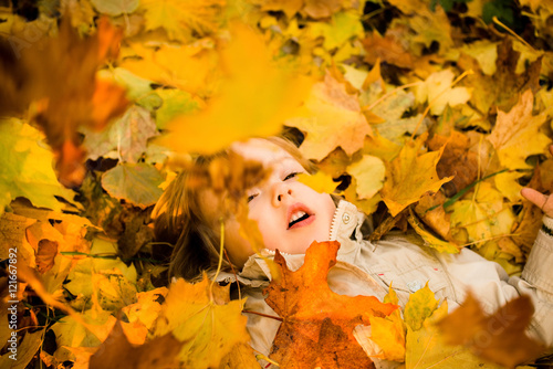 Autumn - child in fallen leaves
