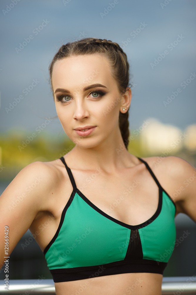 Concept: healthy lifestyle, sport. Attractive happy girl fitness trainer do outdoor workout at modern downtown urban area during sunset. Concept: healthy lifestyle, sport. Attractive happy girl fitness trainer do outdoor workout at modern downtown urban area during sunset.