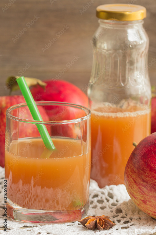 Apple juice and fresh apples on a wooden background. Apple juice and fresh apples on a wooden background.