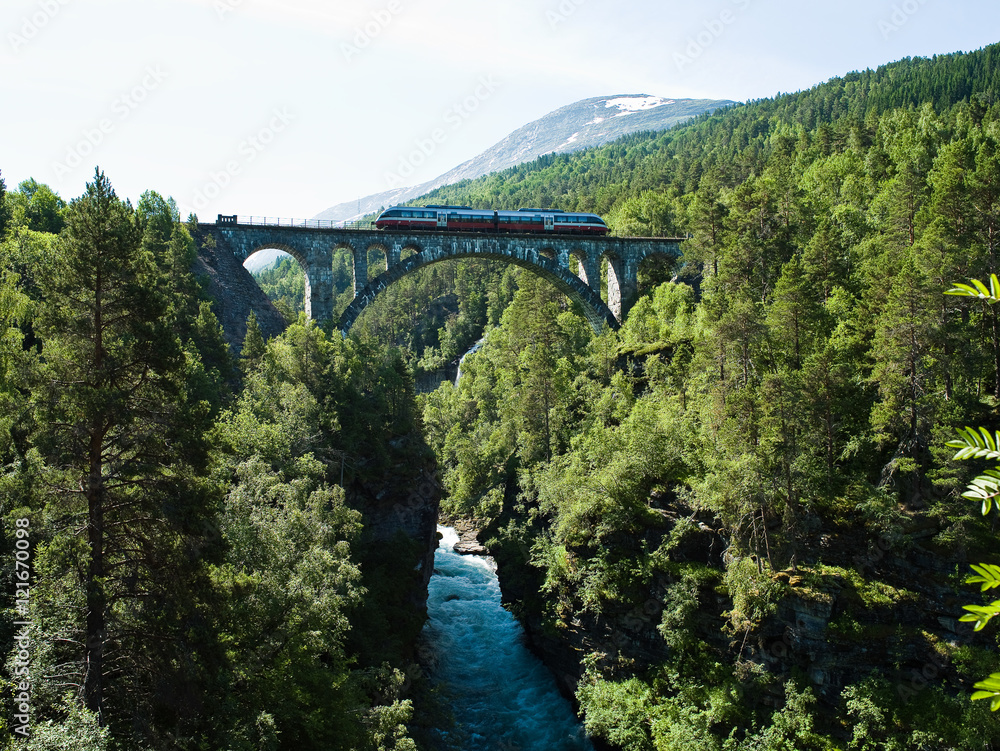 Train crossing Kylling bridge over Rauma river in Romsdalen valley in Norway Train crossing Kylling bridge over Rauma river in Romsdalen valley in Norway