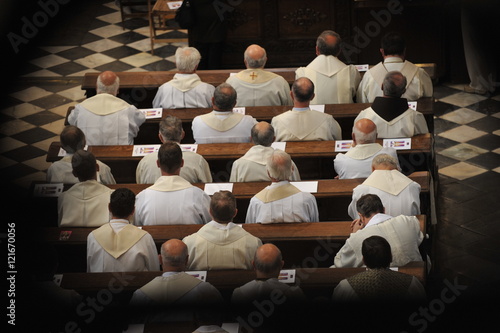 Canvas Print Priests sitting in church.