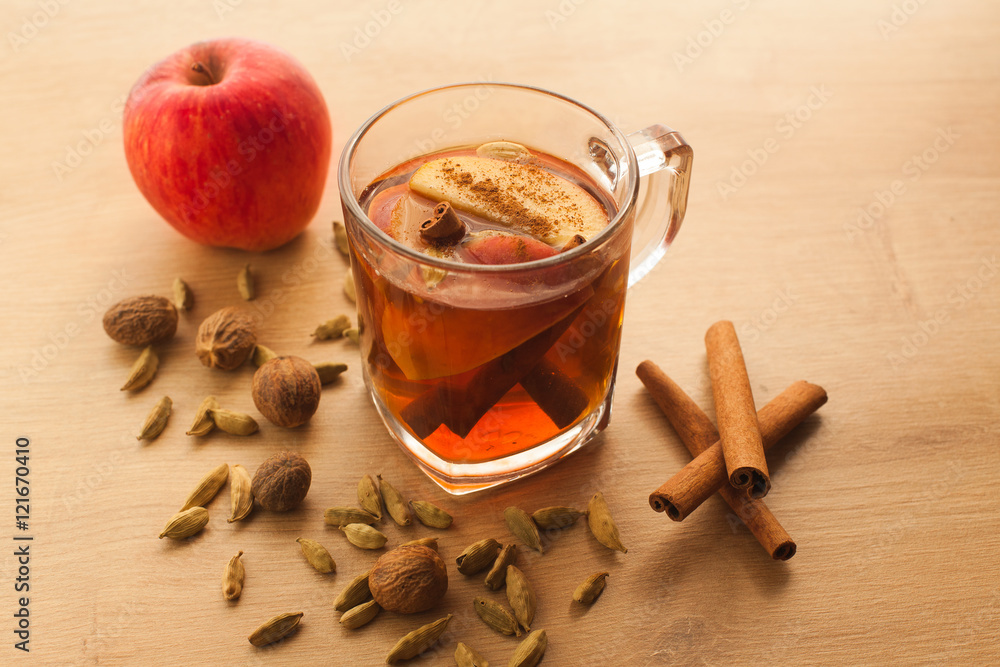 Hot tea with apple, cinnamon and cardamom. Autumn healthy drink to warm yourself in cold weather. Vitamin beverage with spices. Hot tea with apple, cinnamon and cardamom. Autumn healthy drink to warm yourself in cold weather. Vitamin beverage with spices.