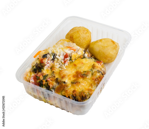 Baked meat with potatoes in a plastic food container. Isolated on white background
