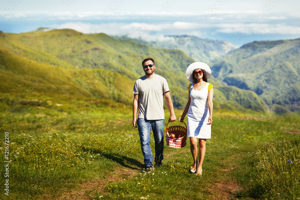 Young couple going with picnic basket