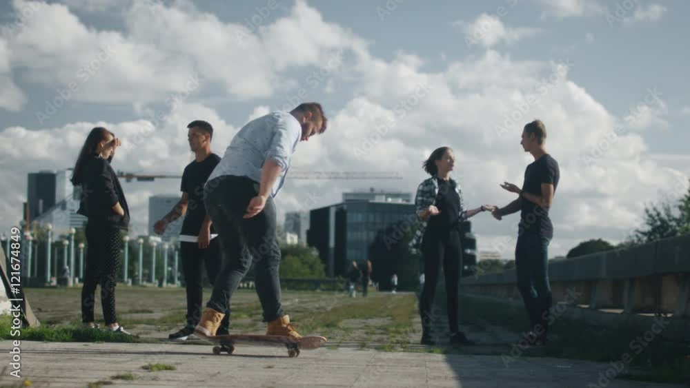 Skateboarder Performing Kickflip for His Teenager Friends. Shot on RED Cinema Camera in 4K (UHD).