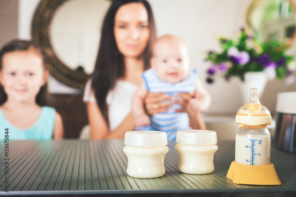 Bottle with milk and manual breast pump