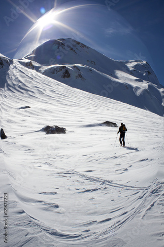 skier making turns in the slope of a mountain