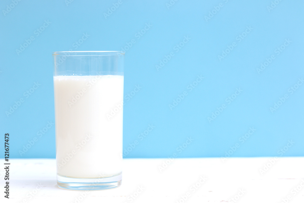 Glass of milk on white wooden table Glass of milk on white wooden table