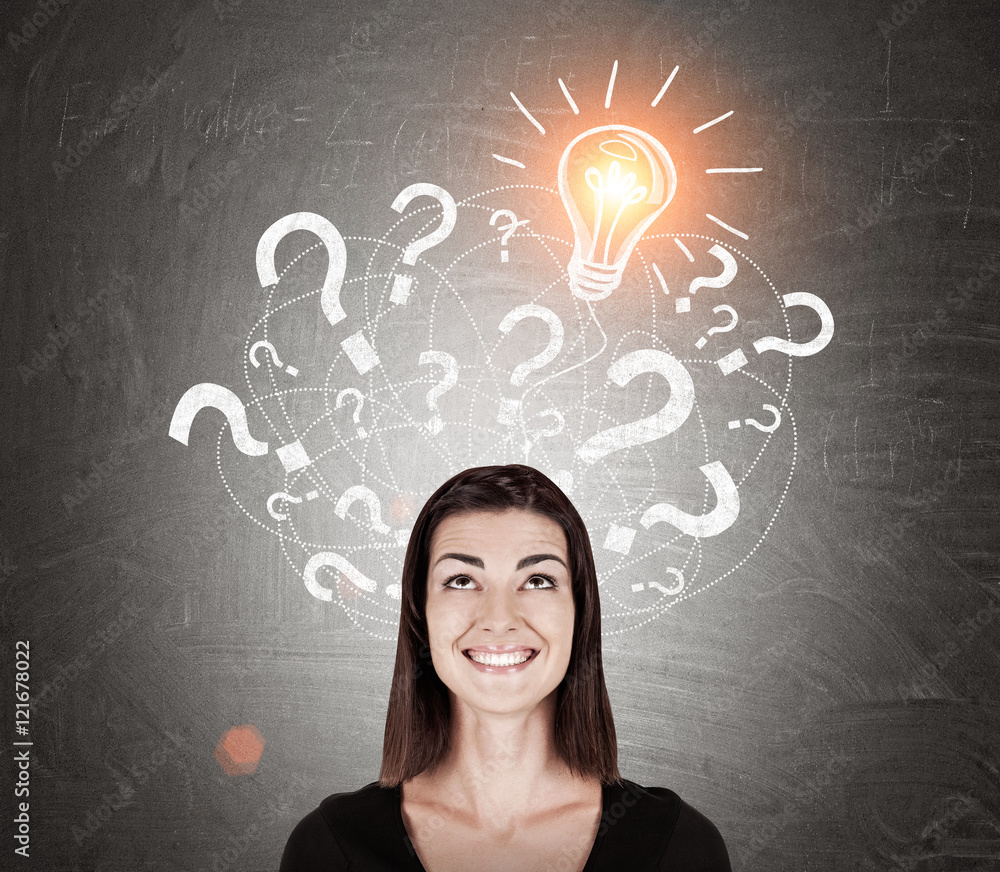 Smiling girl in black and light bulb with question marks Smiling girl in black and light bulb with question marks