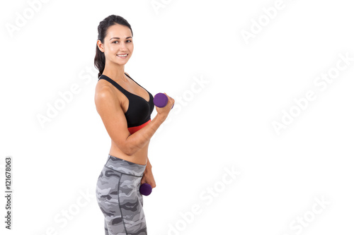 Smiling lady making a dumbbell exercise © ImageFlow