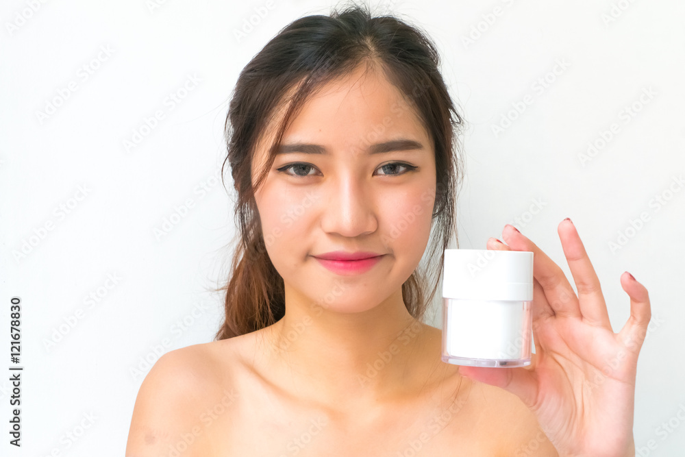 skincare products, Portrait of Beautiful Young Woman looking at skincare products, Portrait of Beautiful Young Woman looking at