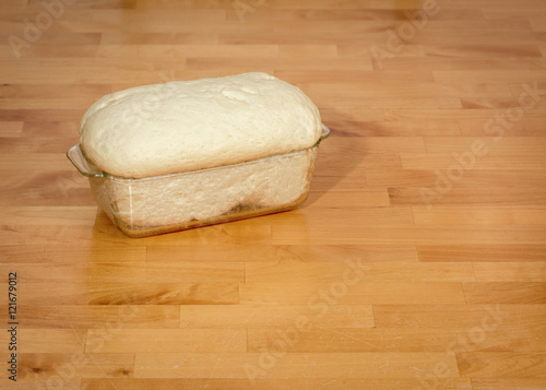 Fresh bread dough in a baking pan
