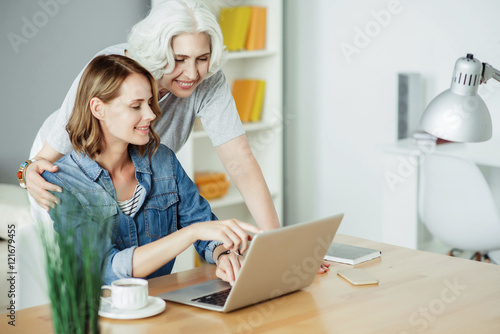 Positive woman using laptop