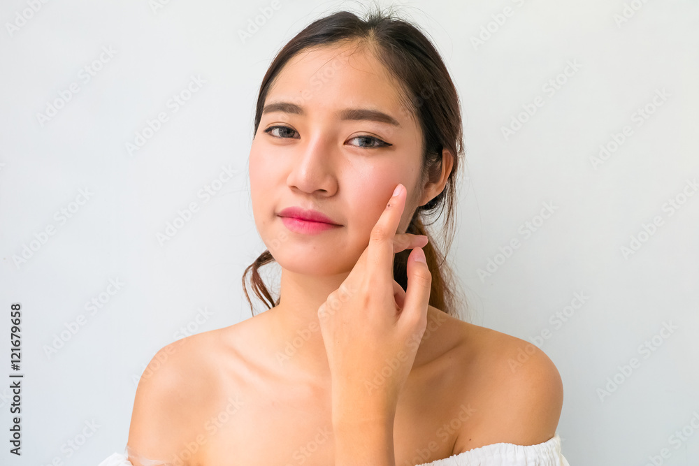 Beautiful woman with healthy clean skin presenting something on Beautiful woman with healthy clean skin presenting something on