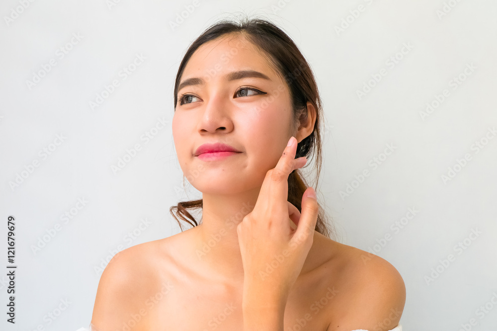 Beautiful woman with healthy clean skin presenting something on Beautiful woman with healthy clean skin presenting something on