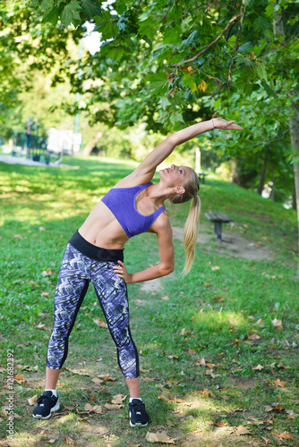 Young girl stretching outdoors. Jogging - workout preparations.