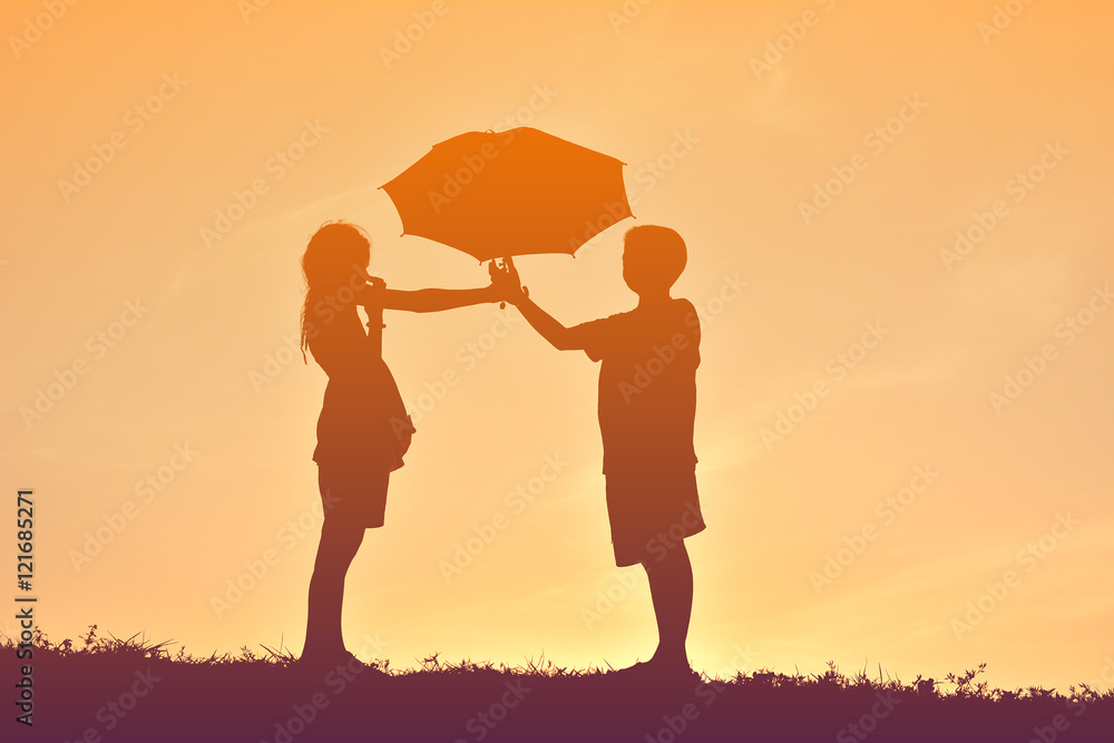 Silhouette children with umbrella on sunset Silhouette children with umbrella on sunset