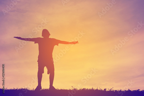 Silhouette happy boy playing on sunset