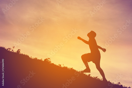 Silhouette a boy running on sunset