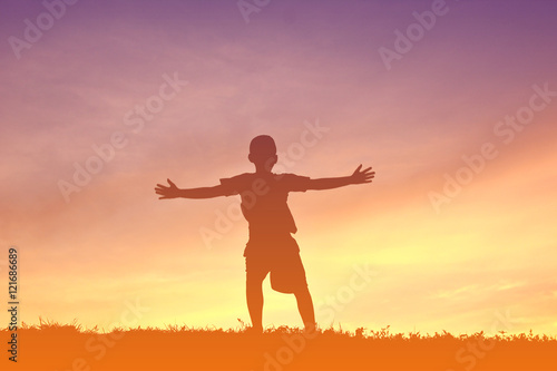 Silhouette a boy relax on sunset