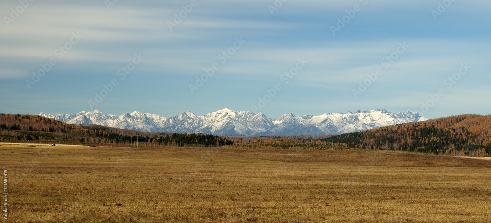 Obraz premium blue sky over the vast steppes, Tunka valley, mountains covered with snow, Sayan mountains. Used deep toning of the photo 