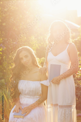 Two sisters and books. Sunset