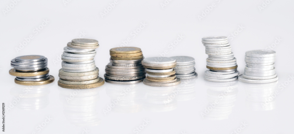 columns of coins from different countries on a white background columns of coins from different countries on a white background