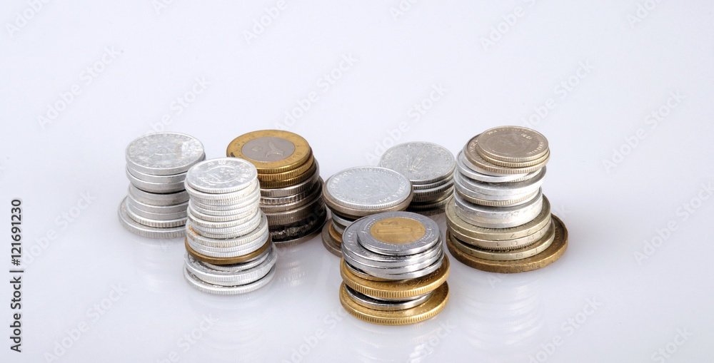 columns of coins from different countries on a white background columns of coins from different countries on a white background