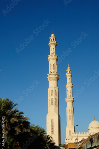 tower minaret of muslim mosque in front of azure blue sky