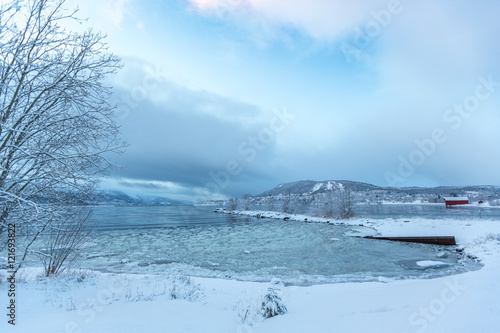 Snow scene of village and lake