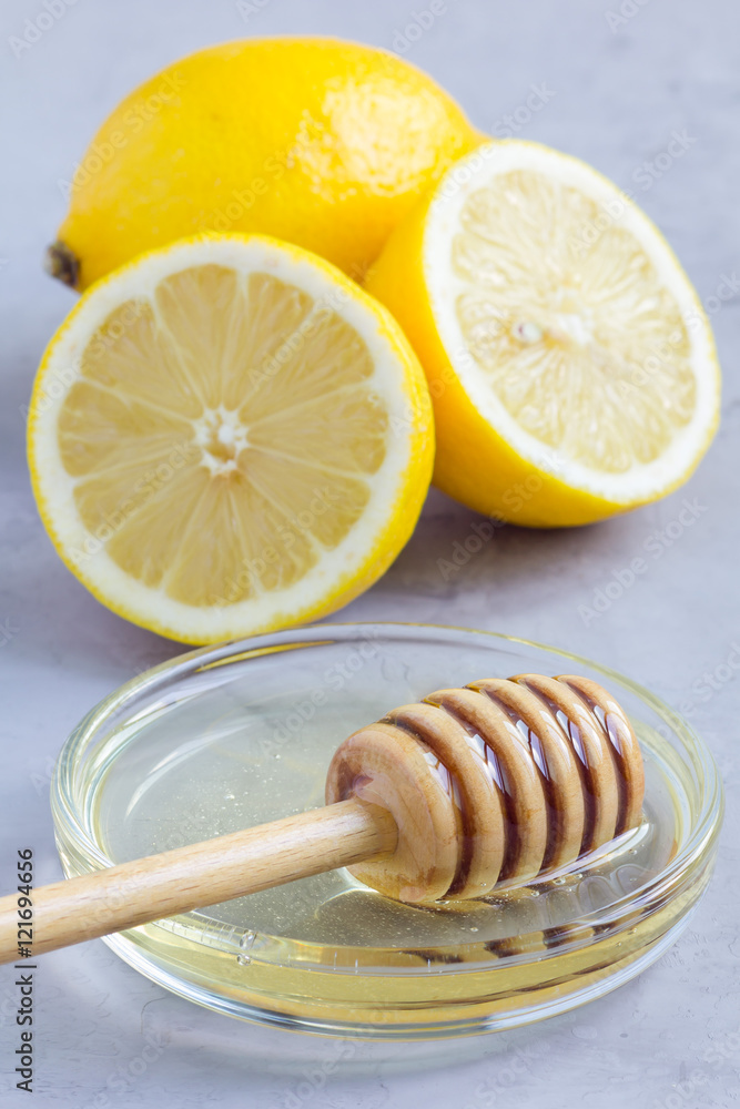 Honey and lemon: cold, flu remedy, concrete background Honey and lemon: cold, flu remedy, concrete background