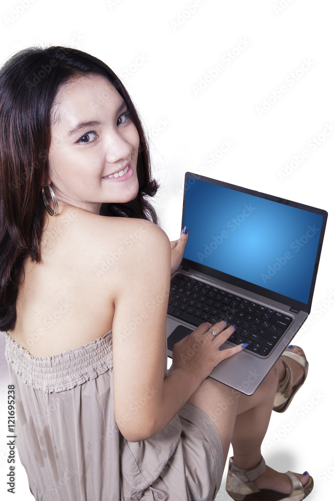 Attractive teenage girl uses laptop Attractive teenage girl uses laptop
