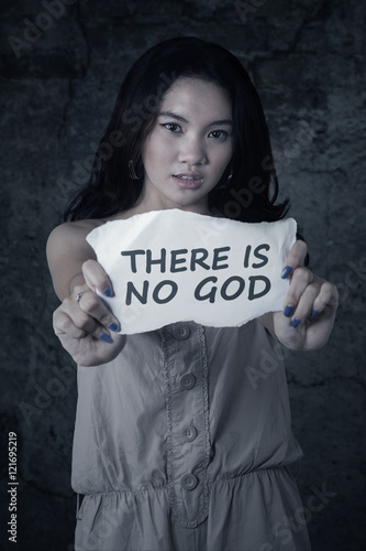 Atheist teenage girl holds paper photo