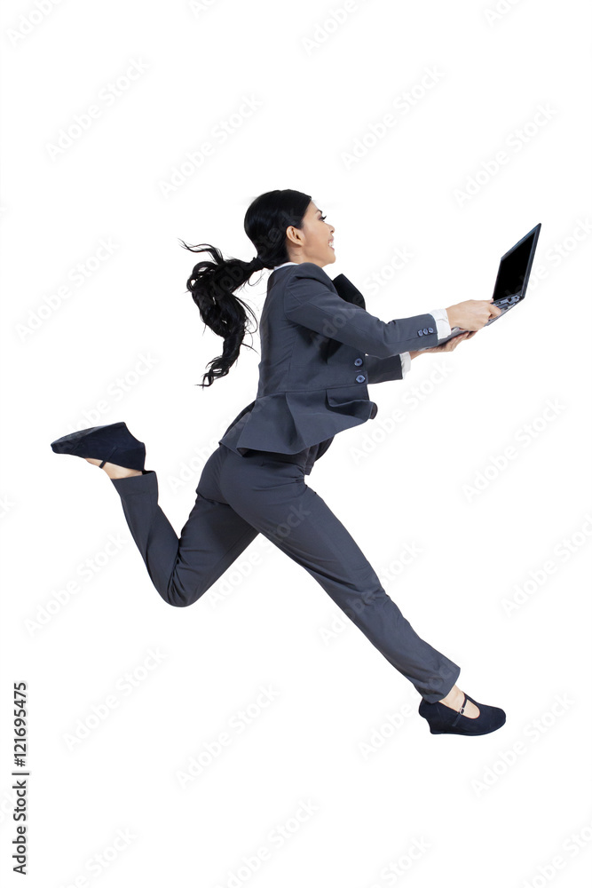 Fototapeta premium Businesswoman holds laptop and runs in studio