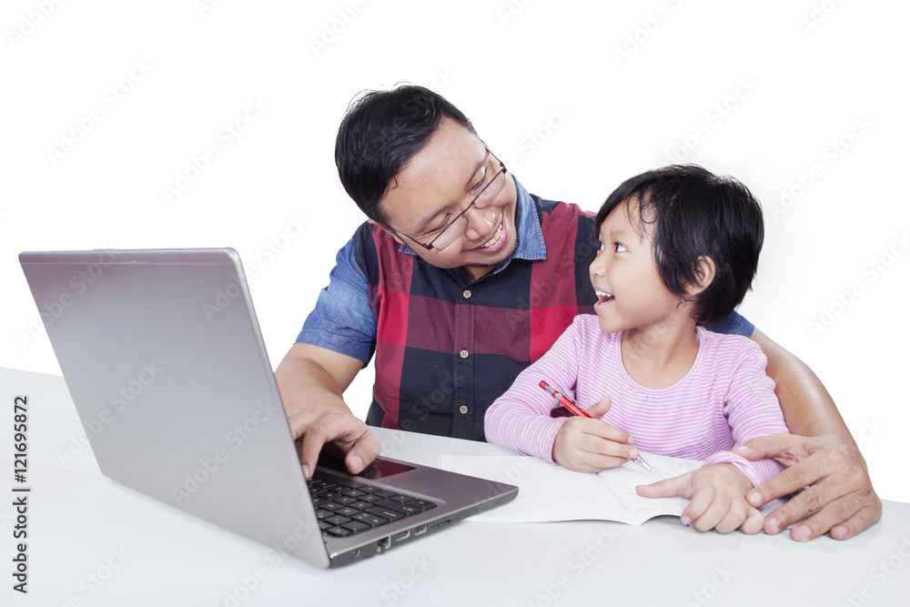 Cute girl talking with dad while studying