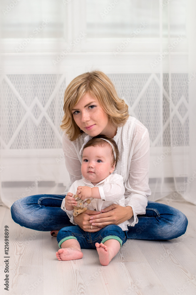 Happy mother plays with here 9 month daughter at home Happy mother plays with here 9 month daughter at home