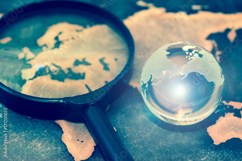 Crystal globe on grunge world map, with lens flare