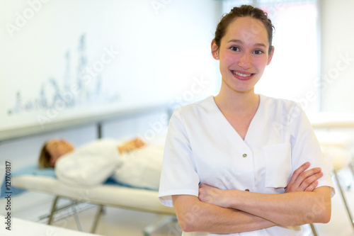 Portrait of a young attractive masseuse in a professional room