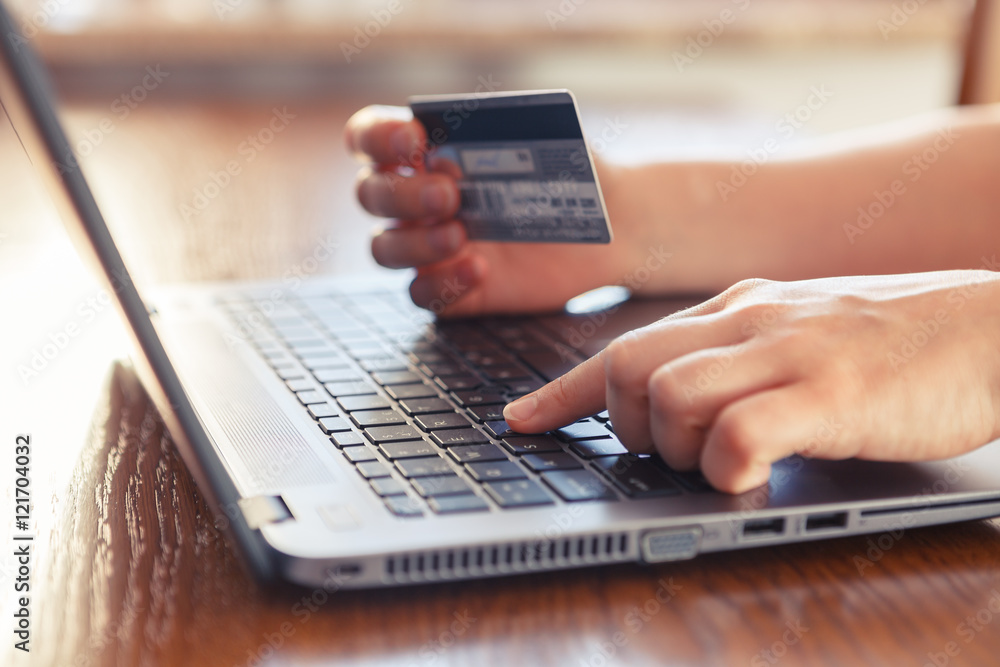 Hands holding credit card and using laptop - online shopping Hands holding credit card and using laptop - online shopping