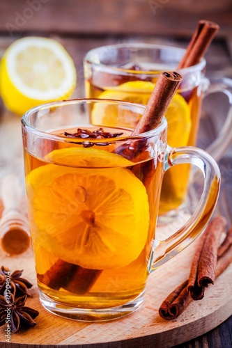 hot tea with lemon, anise and cinnamon in glass mugs