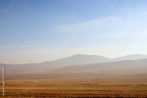  delicate haze of morning mist over the valley. hilly landscape. Savannah, grassland . used toning of the photo