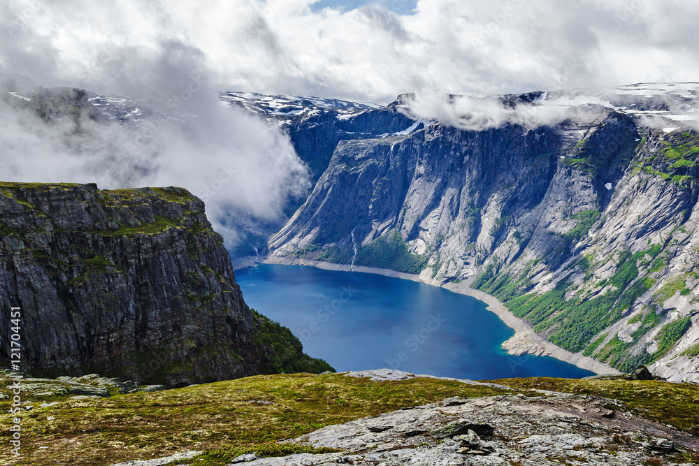 Norway traditional mountain landscape with fjord. Cloudy sky scene.