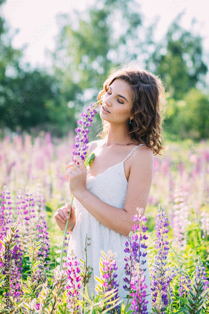 Girl with a bouquet of lupine on the field Girl with a bouquet of lupine on the field